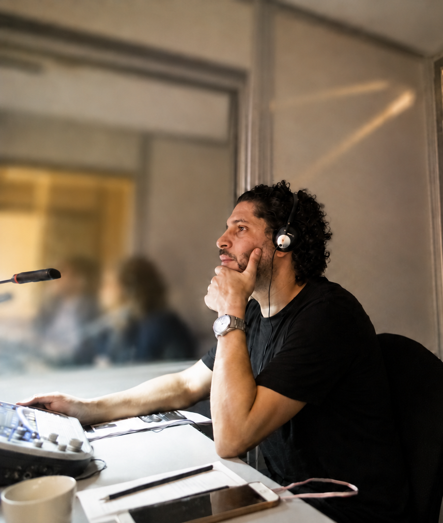 Interpreter at work in a broadcast booth during a technical session